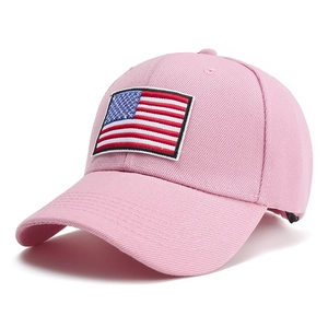 Close-up of pink baseball cap featuring US flag embroidery patch and twill texture