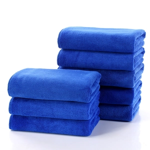 Premium thick dark blue microfiber car wash towels in a neat stack for high absorption