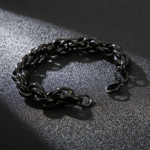 Detailed view of industrial black stainless steel chain bracelet with lobster clasp closure