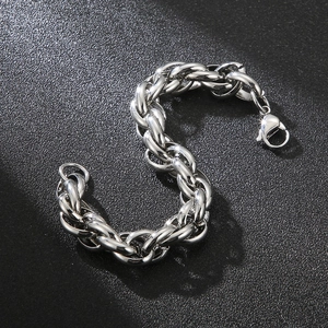 Detailed view of silver thick link chain bracelet with lobster clasp on black background
