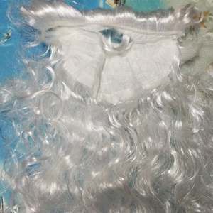 Detail of Santa Claus wig with white curly synthetic fibers and mesh base lining