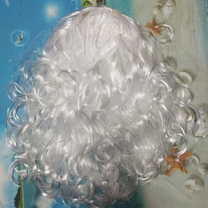 Close-up of curly white Santa Claus wig with breathable mesh lining on a beach background