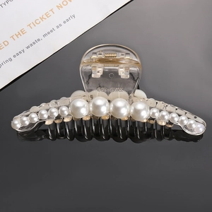 Macro view of transparent hair claw clip with white pearls and XW D-309 engraving