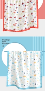 Detail view of cotton gauze baby towels with cartoon transport and dinosaur patterns