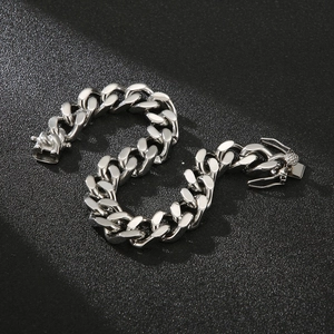 Polished silver cuban link chain bracelet for men with secure clasp on matte background