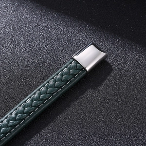 Macro shot of green braided leather bracelet with a polished silver metal clasp