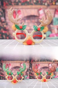 Detail of Christmas reindeer antler glasses with glitter finish and red pom-pom nose