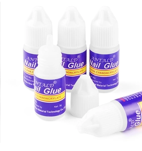 Close-up of five 3g professional nail glue bottles for rhinestones and tips