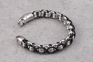 Detail of vintage leather bracelet with stainless steel clasp and woven texture