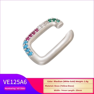 Detail view of gold-plated ear cuff with multi-color cubic zirconia inlay on white base