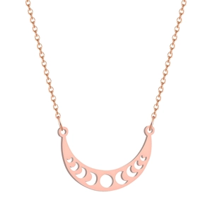 Detailed view of rose gold crescent moon phase cutout pendant on a cross chain necklace