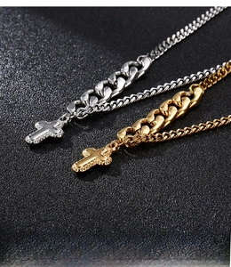 Detailed shot of mixed-link Cuban chains with engraved stainless steel cross pendants