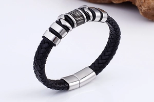 Detail of black braided leather bracelet with silver stainless steel magnetic clasp