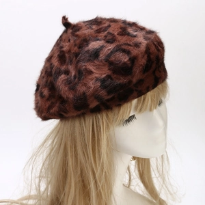 Detail showing the plush texture and leopard print pattern of the rabbit fur beret