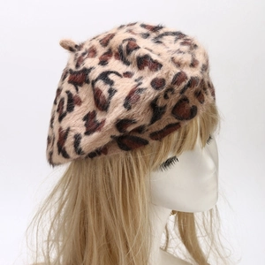 Close-up of leopard print rabbit fur beret on a model showing plush texture and warmth