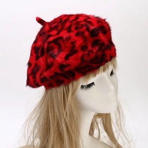 Detail shot of the red and black leopard print plush faux fur texture on beret hat