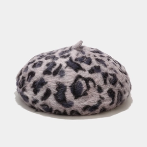 Close-up of soft faux fur leopard print beret in grey blue tone for winter