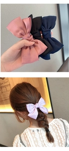 Dettaglio di fiocchi per capelli in raso multicolore e modella con fiocco color lavanda
