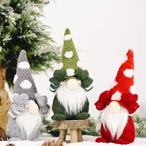 Detailed view of three festive Christmas gnomes in grey, green, and red knit hats