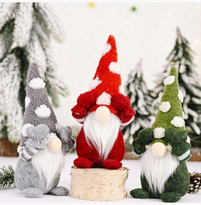 Three plush Christmas gnomes in red, grey, and green with white polka dot hats and soft beards