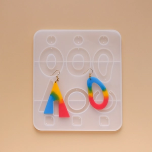 Macro shot of geometric silicone earring molds with colorful resin drop pendants