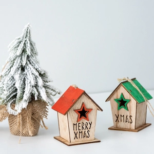 Pair of wooden Christmas house ornaments with Merry Xmas text on snowy tree background