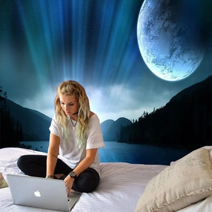 Detail of bedroom wall tapestry featuring abstract blue mountain, moon, and aurora scenery