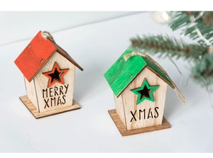 Detail of red and green wooden Christmas house ornaments with Merry Xmas engraving