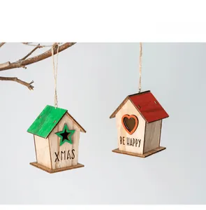 Macro view of handmade wooden birdhouse ornaments with XMAS and BE HAPPY engravings