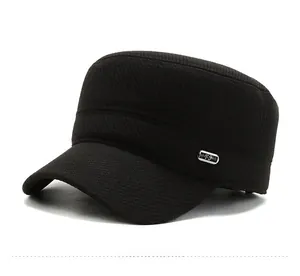 Detail of black military flat top hat with twill texture and metal FS logo on the side
