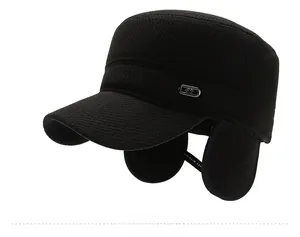 Detail view of winter flat cap for men with ear flaps and metallic FS logo accent