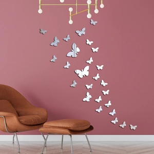 3D acrylic mirror butterfly wall stickers for home decor on a modern pink wall