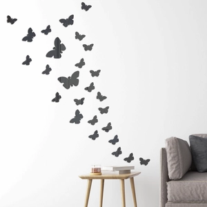Modern 3D black acrylic mirror butterfly wall stickers arranged on a living room wall