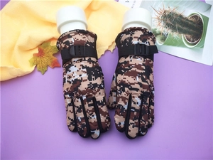 Detail of adjustable wrist strap on kids camouflage ski gloves for winter warmth