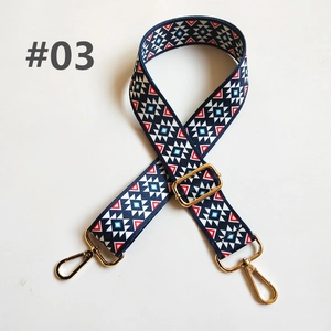 Close-up of geometric ethnic strap with gold metal hooks and adjustable buckle design