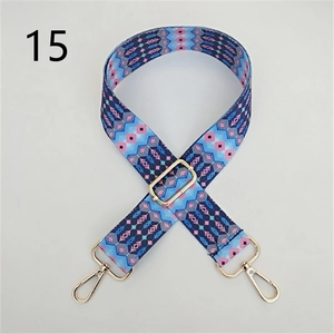 Close-up of ethnic style woven bag strap with geometric patterns and gold metal clips