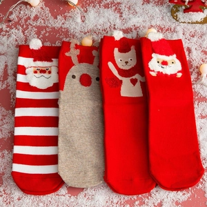 Detail of Christmas crew socks with festive 3D reindeer and Santa Claus plush patterns