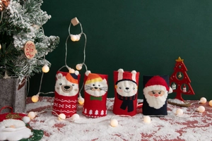 Detailed view of knitted Christmas socks with cartoon bear and Santa Claus patterns