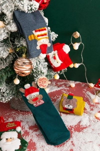 Detailed view of festive knit Christmas socks with 3D cartoon reindeer and bear designs