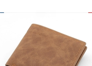 Close-up of the brown leather wallet showing detailed lychee grain texture and stitching
