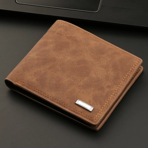 Classic brown leather bi-fold men's wallet in a professional business desk setting