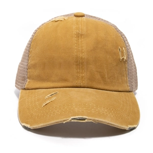 Detail of distressed ponytail baseball cap featuring frayed edges and breathable mesh panels