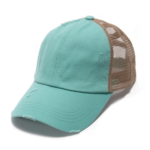 Detail of vintage washed denim trucker hat with ponytail hole and frayed brim