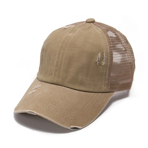 Detail of distressed cotton baseball cap with worn edges and breathable mesh back