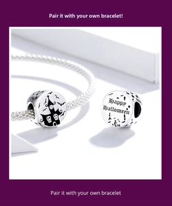 Macro detail of S925 sterling silver Halloween charm with haunted house and bat engraving