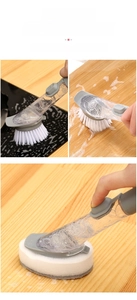 Detail of kitchen dish brush with long handle, liquid soap dispenser and brush head options