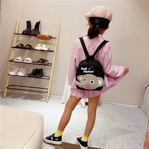 Detail of child's black canvas backpack with a cute grey elephant patch and small heart