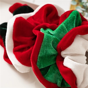 Close-up of soft velvet Christmas scrunchies in festive red, green and white colors