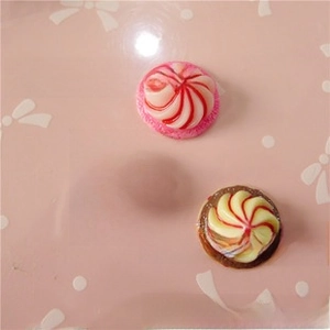 Flat lay of resin cream swirl pendants in pink, red and yellow for DIY phone case making