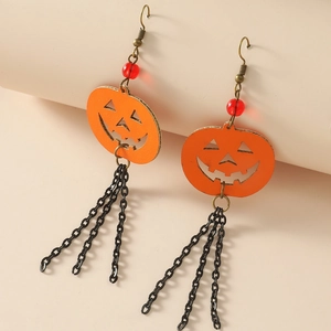Detail of Halloween pumpkin earrings with orange texture and black metal chain fringe